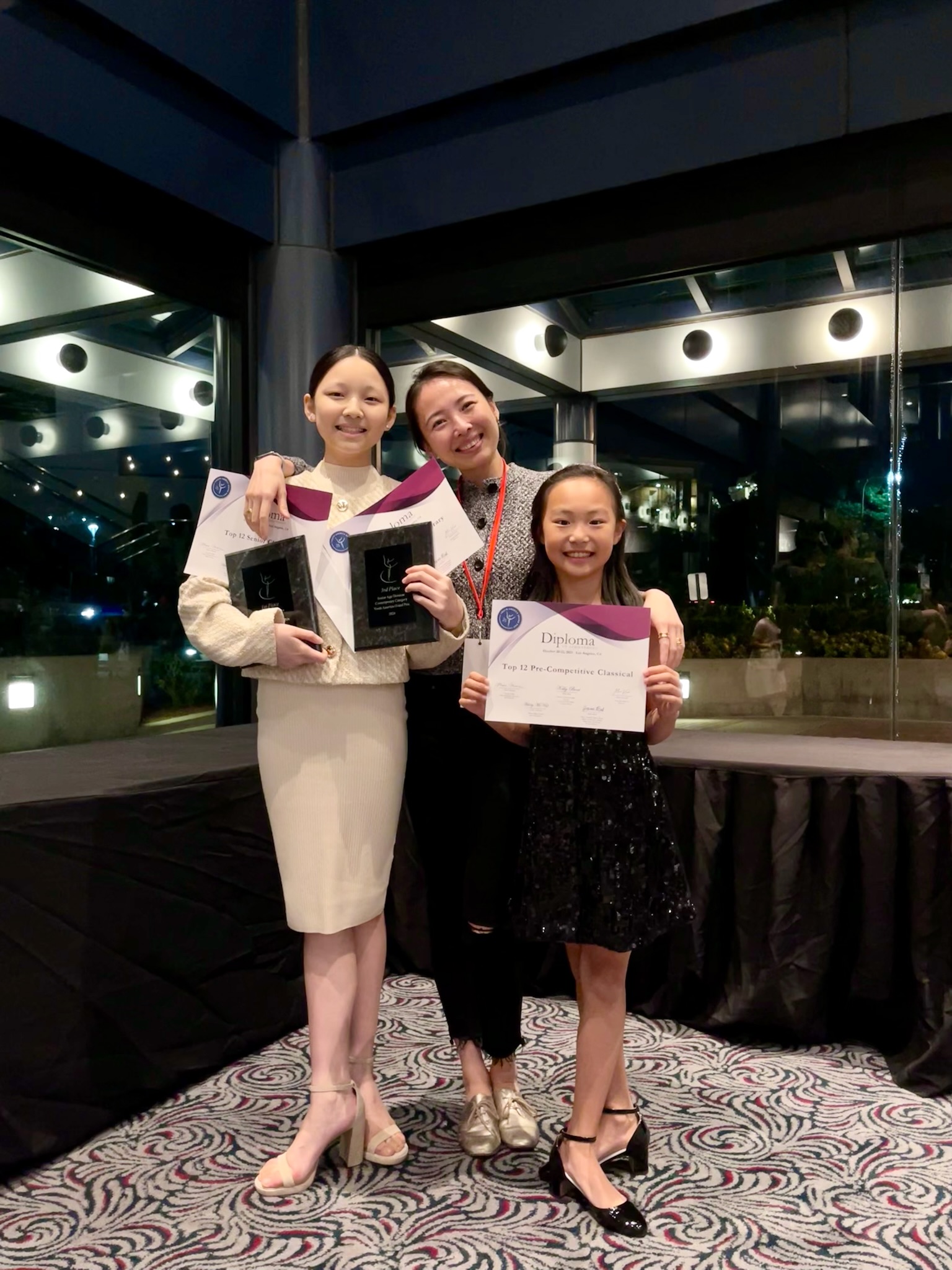 Mi Deng with students celebrating competition awards