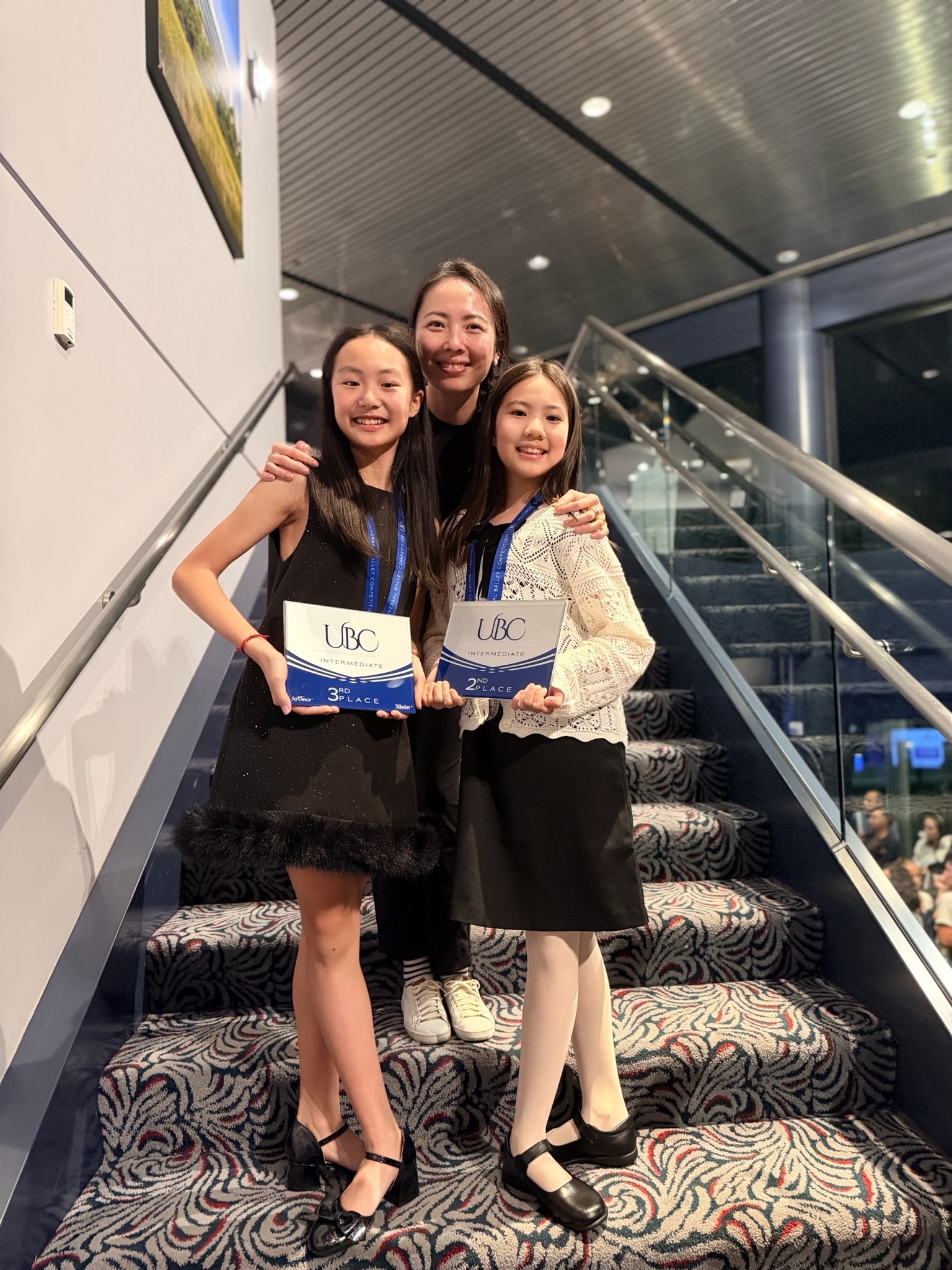 Mi Deng with students holding UBC placements